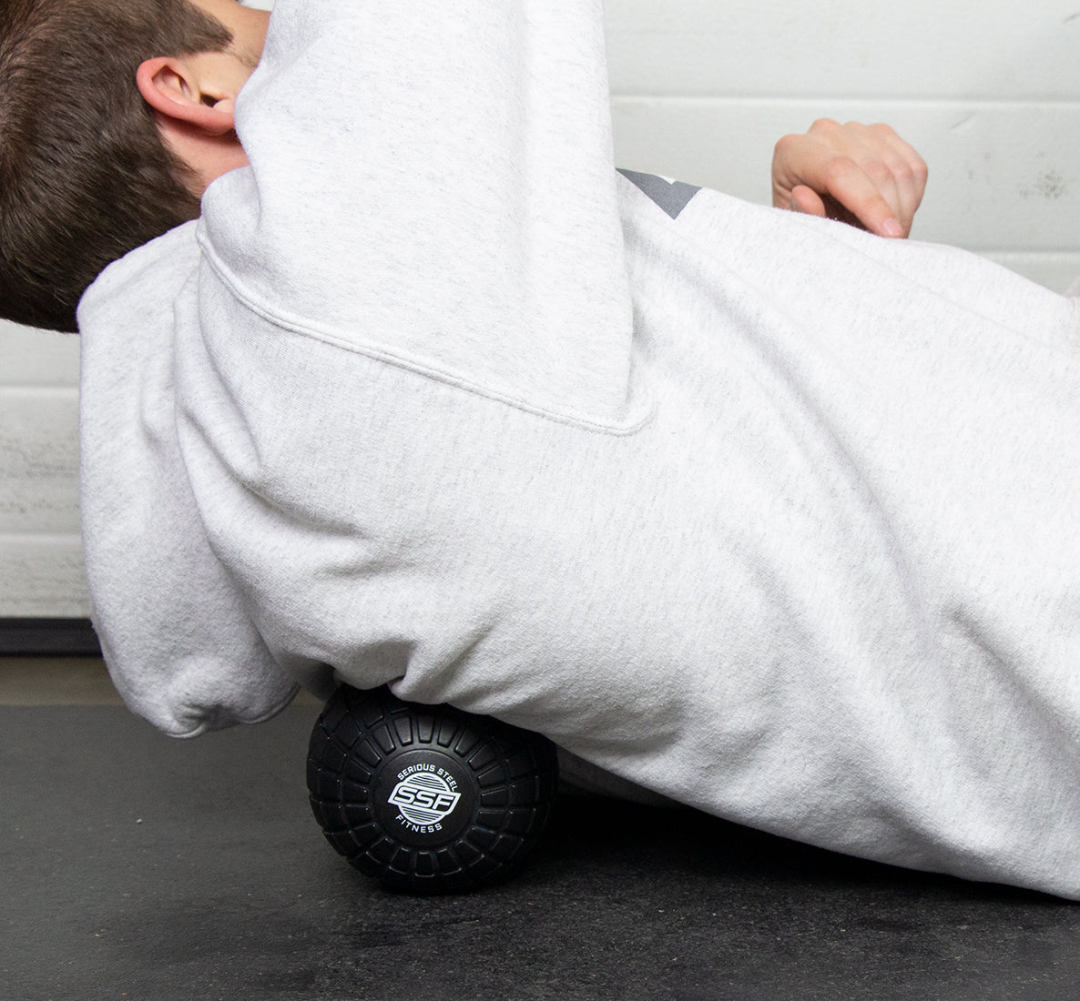 SSF-Black-Massage-Ball_In-Use-On-Back-On-Black-Mat_Cropped-1.jpg